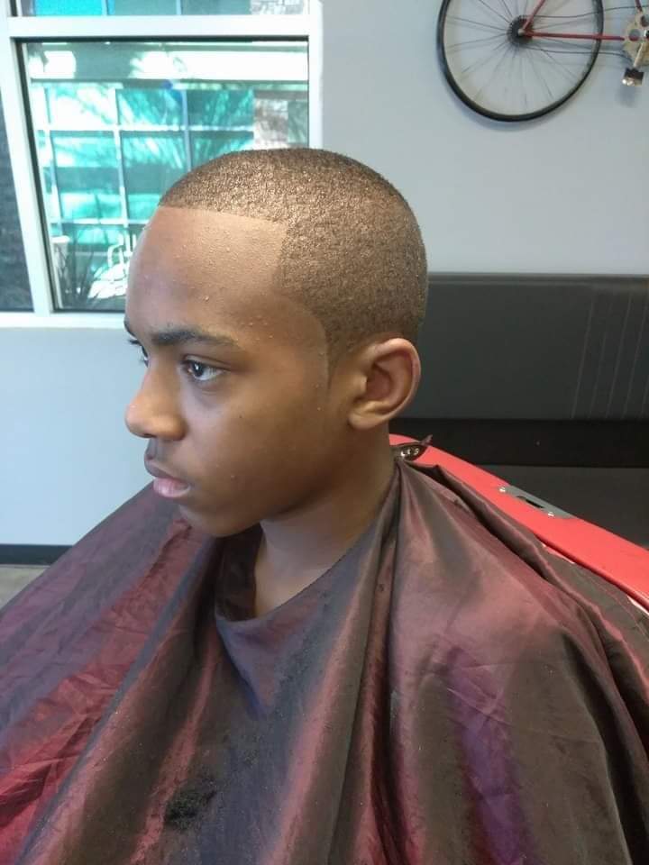 Side profile of a young man with a short fade haircut