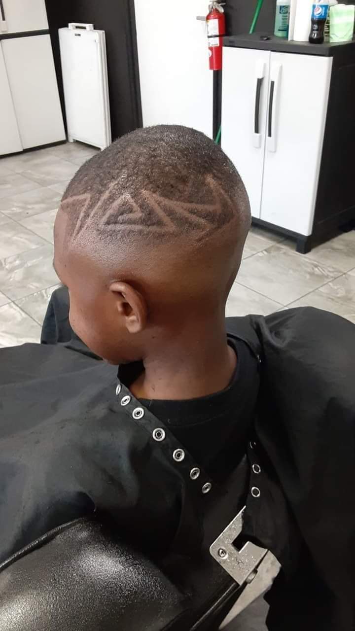 Back of a boy's head showing a geometric star hair design